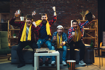 Image showing Group of friends watching TV, sport match together. Emotional fans cheering for favourite team, watching on exciting game. Concept of friendship, leisure activity, emotions