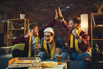 Image showing Group of friends watching TV, sport match together. Emotional fans cheering for favourite team, watching on exciting game. Concept of friendship, leisure activity, emotions