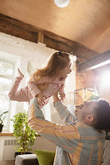 Image showing Happy father and little cute daughter at home. Family time, togehterness, parenting and happy childhood concept. Weekend with sincere emotions.