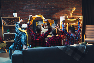 Image showing Group of friends watching TV, sport match together. Emotional fans cheering for favourite team. Top view. Concept of friendship, leisure activity, emotions