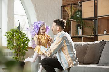 Image showing Happy father and little cute daughter at home. Family time, togehterness, parenting and happy childhood concept. Weekend with sincere emotions.