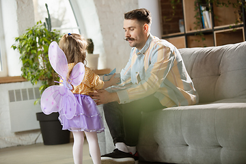 Image showing Happy father and little cute daughter at home. Family time, togehterness, parenting and happy childhood concept. Weekend with sincere emotions.