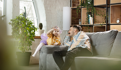 Image showing Happy father and little cute daughter at home. Family time, togehterness, parenting and happy childhood concept. Weekend with sincere emotions.