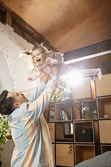 Image showing Happy father and little cute daughter at home. Family time, togehterness, parenting and happy childhood concept. Weekend with sincere emotions.