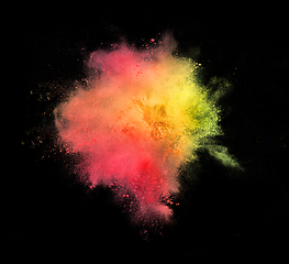 Image showing Explosion of colored, fluid and neoned powder on black studio background with copyspace