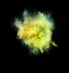 Image showing Explosion of colored, fluid and neoned powder on black studio background with copyspace