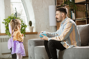 Image showing Happy father and little cute daughter at home. Family time, togehterness, parenting and happy childhood concept. Weekend with sincere emotions.