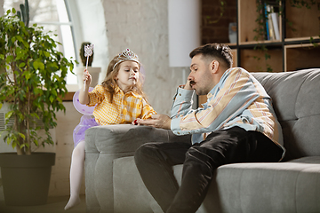 Image showing Happy father and little cute daughter at home. Family time, togehterness, parenting and happy childhood concept. Weekend with sincere emotions.