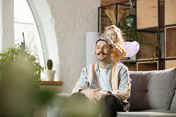 Image showing Happy father and little cute daughter at home. Family time, togehterness, parenting and happy childhood concept. Weekend with sincere emotions.