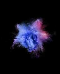 Image showing Explosion of colored, fluid and neoned powder on black studio background with copyspace