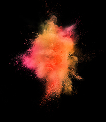 Image showing Explosion of colored, fluid and neoned powder on black studio background with copyspace