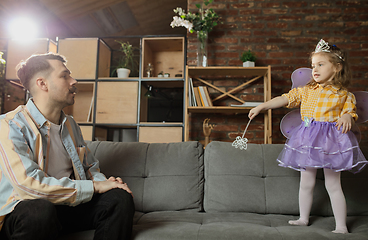 Image showing Happy father and little cute daughter at home. Family time, togehterness, parenting and happy childhood concept. Weekend with sincere emotions.