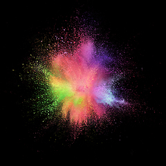 Image showing Explosion of colored, fluid and neoned powder on black studio background with copyspace