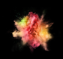 Image showing Explosion of colored, fluid and neoned powder on black studio background with copyspace