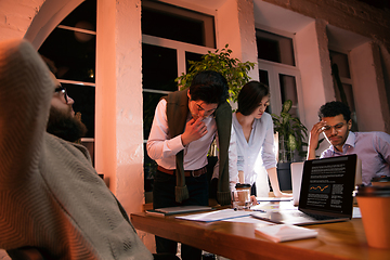 Image showing Colleagues working together in modern office using devices and gadgets during creative meeting