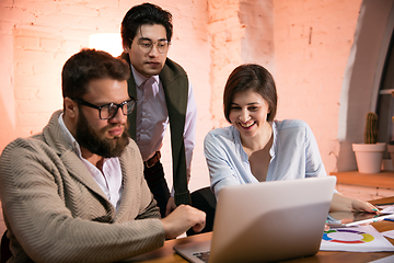 Image showing Colleagues working together in modern office using devices and gadgets during creative meeting