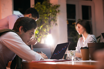 Image showing Colleagues working together in modern office using devices and gadgets during creative meeting