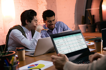 Image showing Colleagues working together in modern office using devices and gadgets during creative meeting