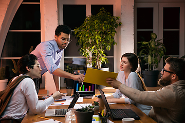 Image showing Colleagues working together in modern office using devices and gadgets during creative meeting