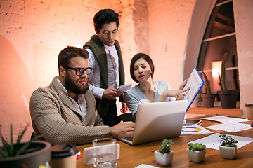 Image showing Colleagues working together in modern office using devices and gadgets during creative meeting