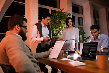 Image showing Colleagues working together in modern office using devices and gadgets during creative meeting