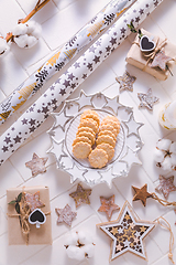 Image showing Christmas time, homemade cookies with ornaments and winter decorations in white