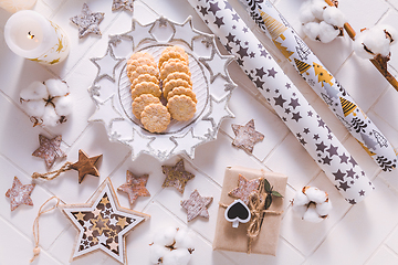 Image showing Christmas time, homemade cookies with ornaments and winter decorations in white