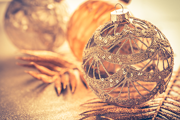 Image showing Christmas ornaments in golden tones