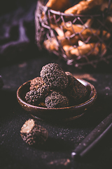 Image showing Black truffle in bowl on dark background