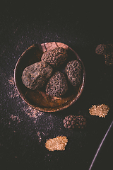 Image showing Black truffle in bowl on dark background