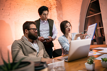 Image showing Colleagues working together in modern office using devices and gadgets during creative meeting