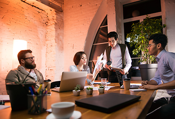 Image showing Colleagues working together in modern office using devices and gadgets during creative meeting