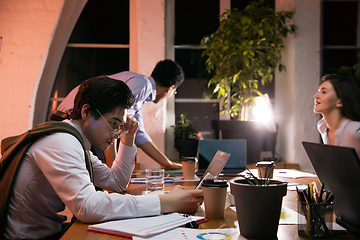 Image showing Colleagues working together in modern office using devices and gadgets during creative meeting