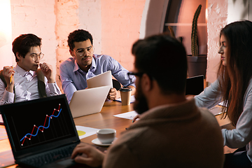 Image showing Colleagues working together in modern office using devices and gadgets during creative meeting