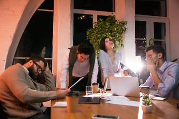 Image showing Colleagues working together in modern office using devices and gadgets during creative meeting