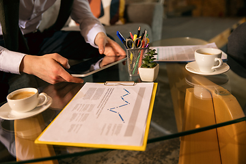 Image showing Close up manager working in modern office using devices and gadgets during creative meeting