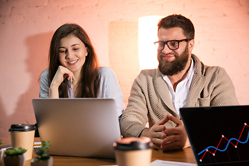 Image showing Colleagues working together in modern office using devices and gadgets during creative meeting