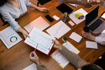 Image showing Colleagues working together in modern office using devices and gadgets during creative meeting