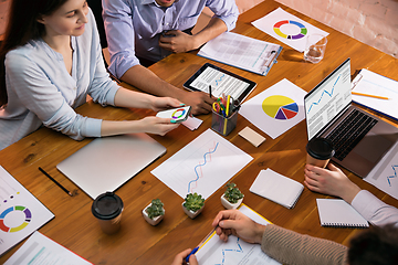 Image showing Colleagues working together in modern office using devices and gadgets during creative meeting