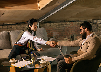 Image showing Colleagues working together in modern office using devices and gadgets during creative meeting