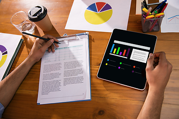 Image showing Close up manager working in modern office using devices and gadgets during creative meeting