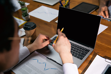 Image showing Close up manager working in modern office using devices and gadgets during creative meeting