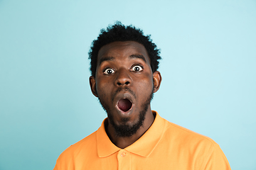 Image showing African man\'s portrait isolated over blue studio background with copyspace