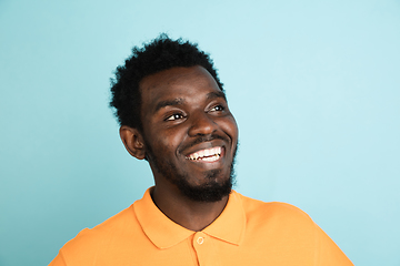 Image showing African man\'s portrait isolated over blue studio background with copyspace