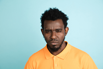 Image showing African man\'s portrait isolated over blue studio background with copyspace