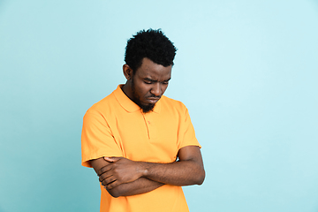 Image showing African man\'s portrait isolated over blue studio background with copyspace