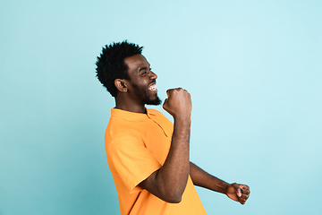 Image showing African man\'s portrait isolated over blue studio background with copyspace