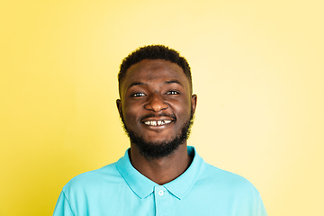 Image showing Portrait of young African man isolated over yellow studio background with copyspace.