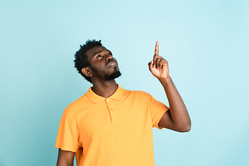 Image showing African man\'s portrait isolated over blue studio background with copyspace