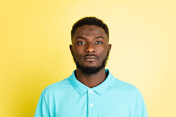 Image showing Portrait of young African man isolated over yellow studio background with copyspace.
